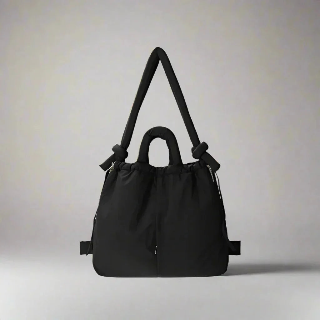 Fashionable women's tote bag: quilted puffer style with functional drawstring sides & elegant knot strap.