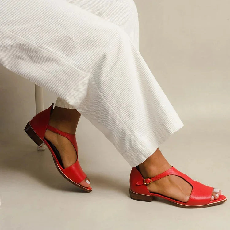 Women's red flat T-strap sandals with open-toe & buckle. Perfect for summer, casual elegant comfort & everyday style.