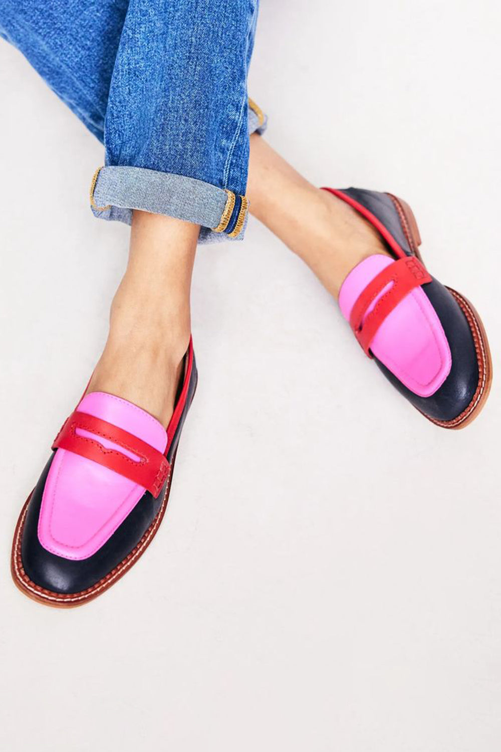 Women's red & pink color-block fashion loafers; modern slip-on flats for comfortable, smart casual style.
