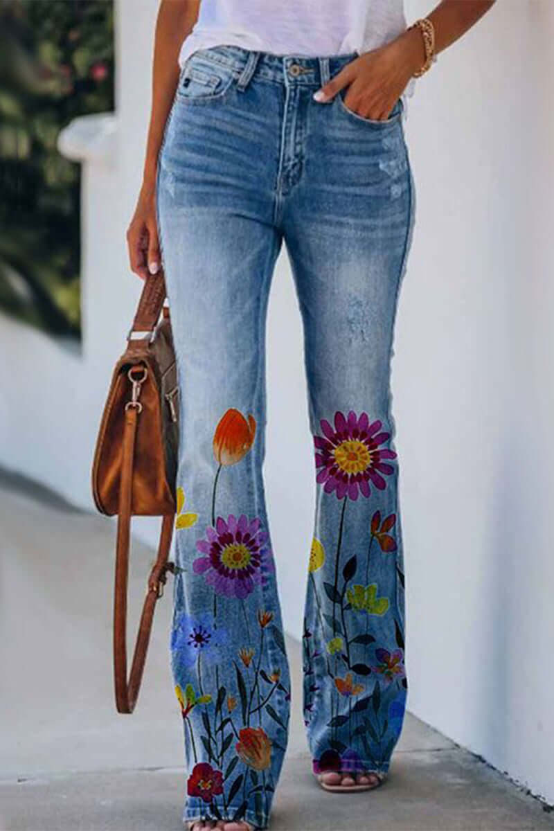 Close-up of intricate floral embroidery on the pocket of women's blue regular fit fashion jeans.