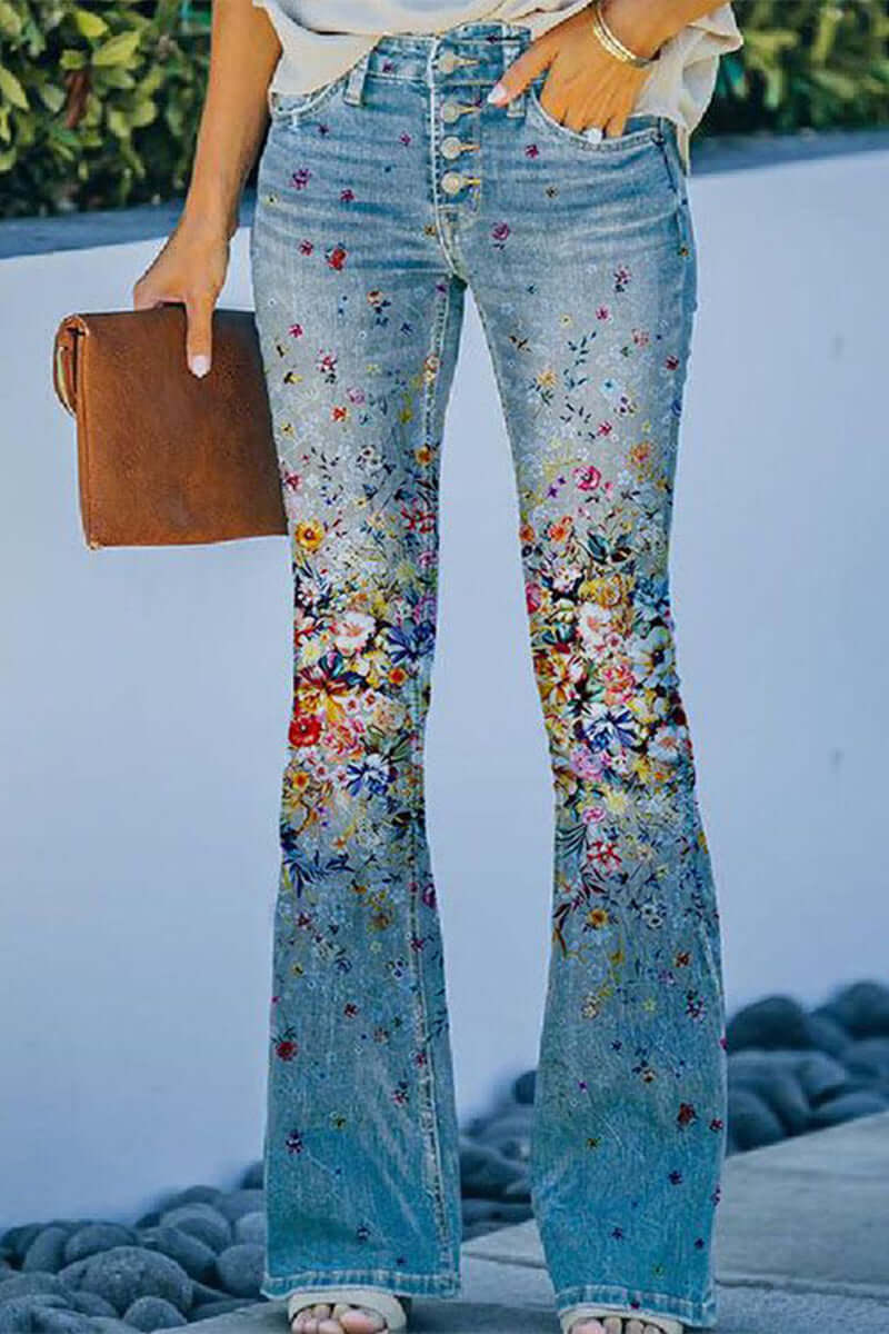Full-length shot of women's stylish blue denim jeans with floral embroidery and regular fit.