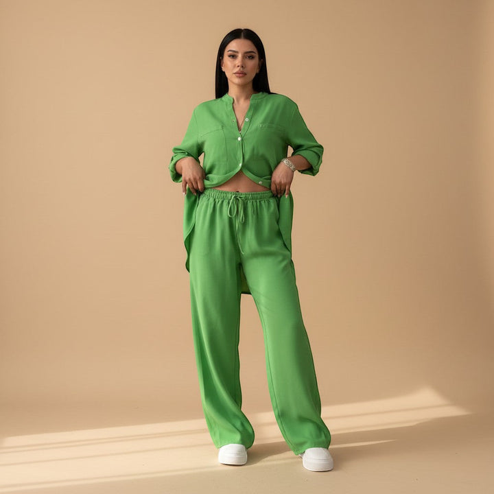 Model in women's relaxed fit two-piece lounge set, with button down shirt & wide leg pants. Casual outfit.