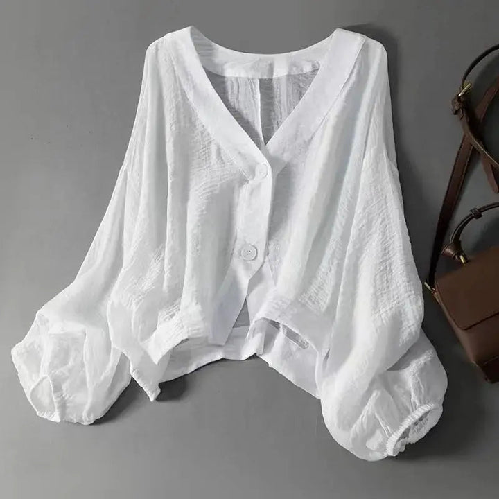 Women's relaxed cotton linen batwing sleeve blouse with elegant button detail, perfect for casual or smart-casual wear.