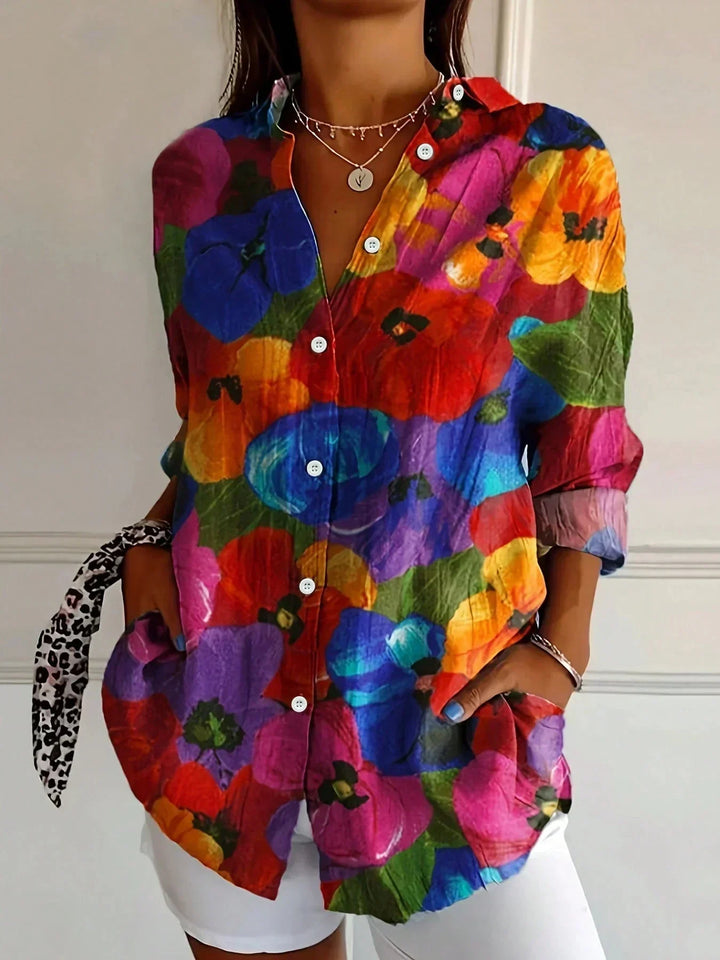 Women's relaxed fit blouse featuring a vibrant abstract print, perfect as a colorful top for casual wear.