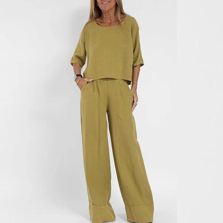 Chic women's matching relaxed-fit blouse and wide-leg pants set, versatile for elegant casual wear.