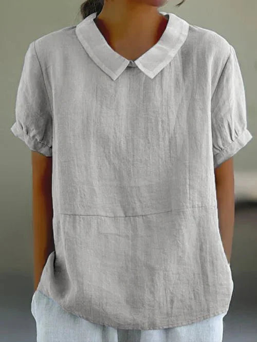Elegant women's blouse featuring a charming Peter Pan collar & relaxed fit. Perfect for work or casual.