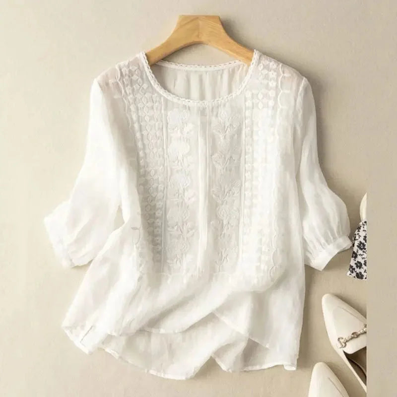 Women's relaxed fit blouse with intricate floral embroidery & stylish puff sleeves. Perfect for spring & summer.