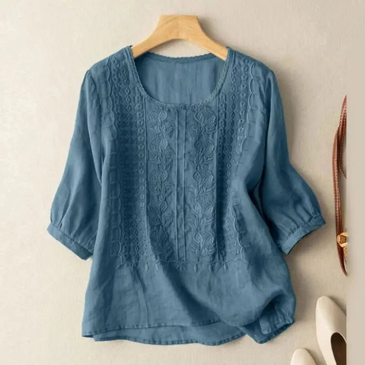 Elegant women's floral embroidered blouse with puff sleeves, versatile for casual or dressy spring/summer outfits.
