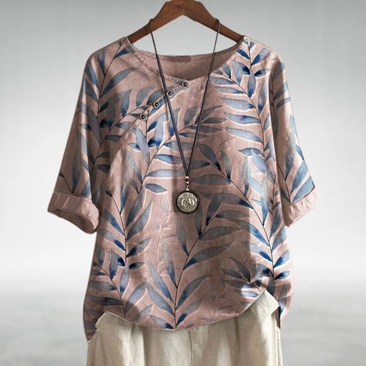Elegant women's relaxed fit botanical print blouse, featuring stylish 3/4 sleeves and a versatile button neck.