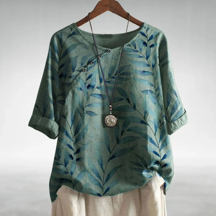 Stylish women's botanical print blouse with 3/4 sleeves, ideal for casual spring fashion or elegant summer style.
