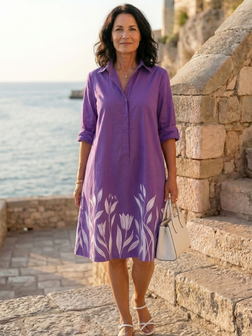 Women's relaxed fit botanical print evening dress with purple floral design, knee-length, perfect for garden parties.