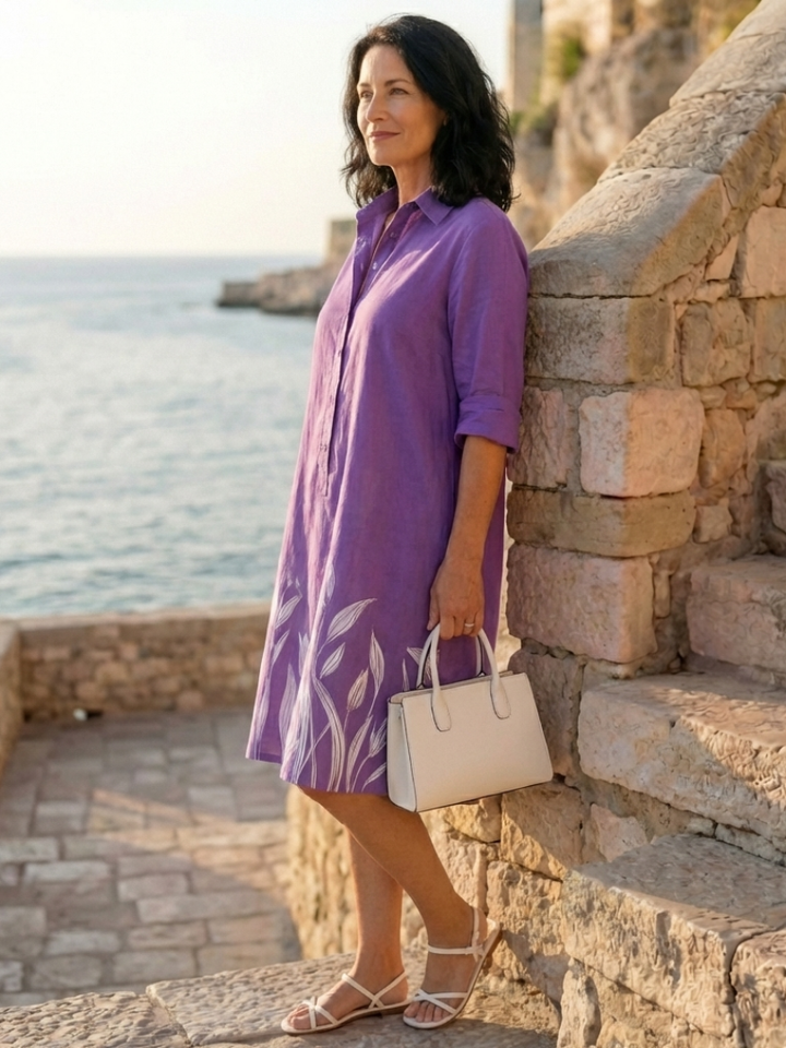 Elegant women's purple botanical print dress. Relaxed fit, collared, three-quarter sleeves, with pockets for casual elegance.