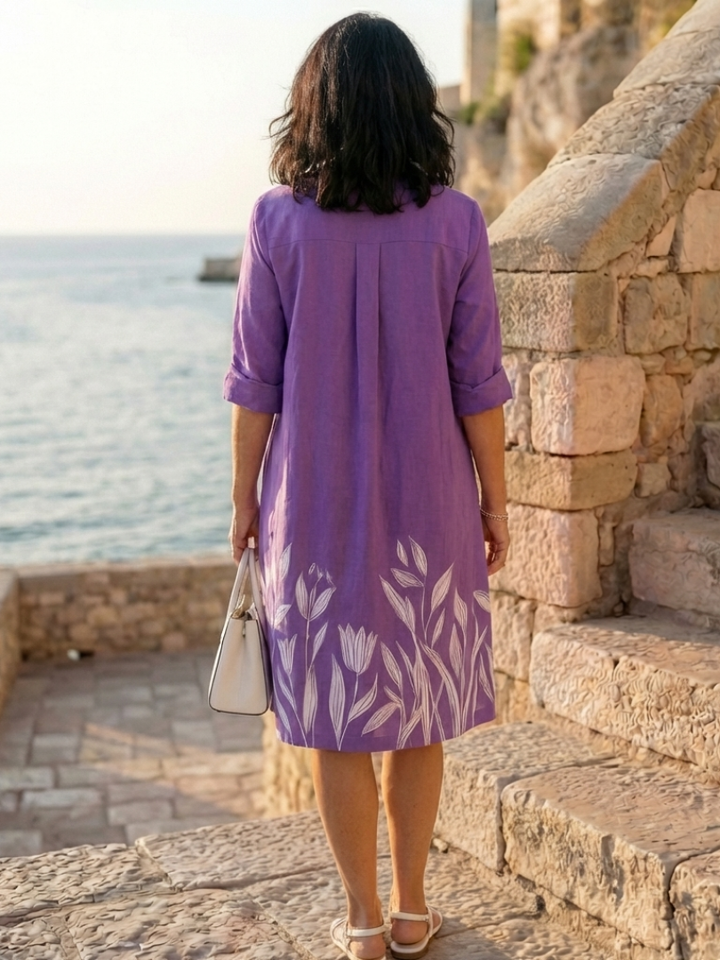 Women's knee-length purple floral botanical print dress. Relaxed fit, three-quarter sleeve, collared, an elegant garden party dress.