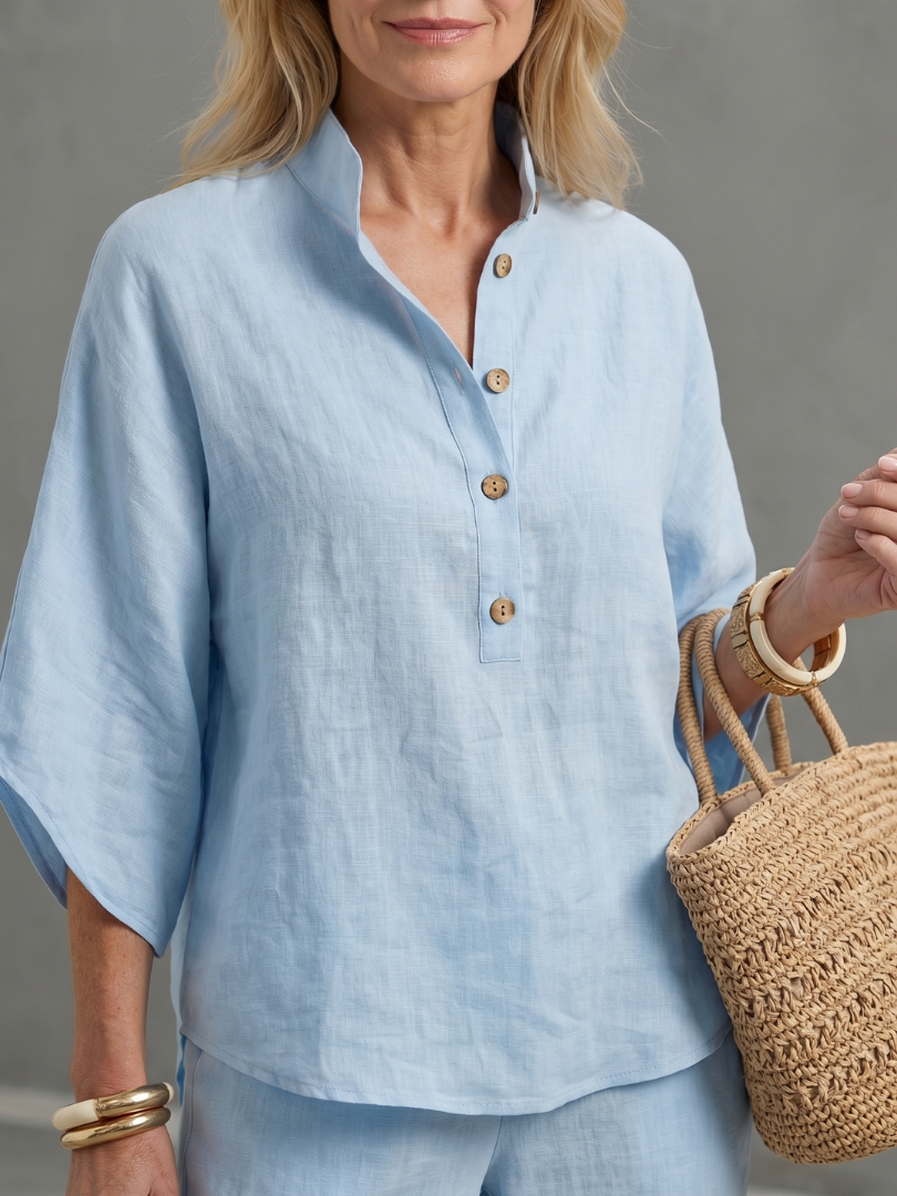 Elegant women's relaxed tunic and straight leg trouser set with stand collar detail.