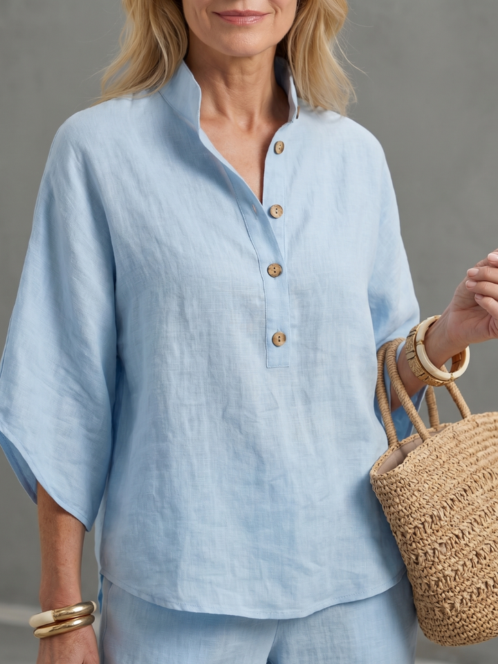 Elegant women's relaxed tunic and straight leg trouser set with stand collar detail.