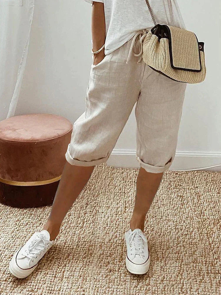 Women's relaxed fit cropped trousers in breathable fabric, perfect for comfortable warm weather wear.