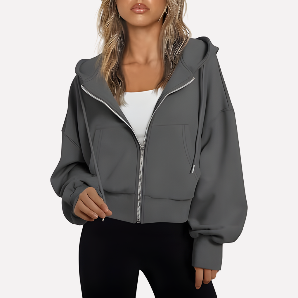 Modern women's cropped zip hoodie, relaxed fit, drawstring details, versatile layering.