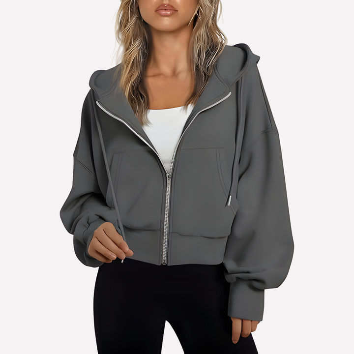 Modern women's cropped zip hoodie, relaxed fit, drawstring details, versatile layering.