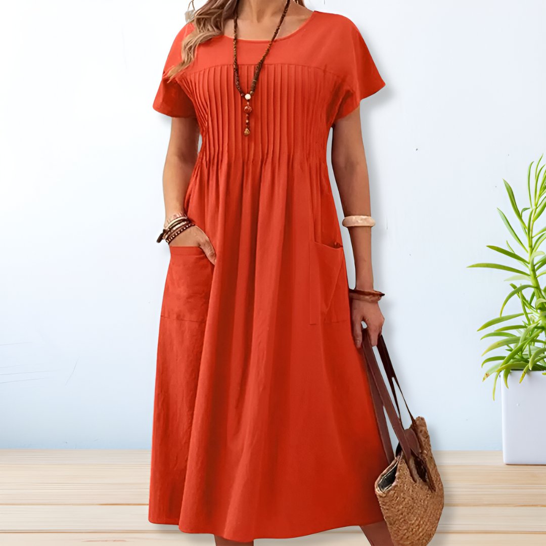 Flowy blue relaxed fit day dress for women, offering tummy coverage, short sleeves, and pockets for casual comfort.
