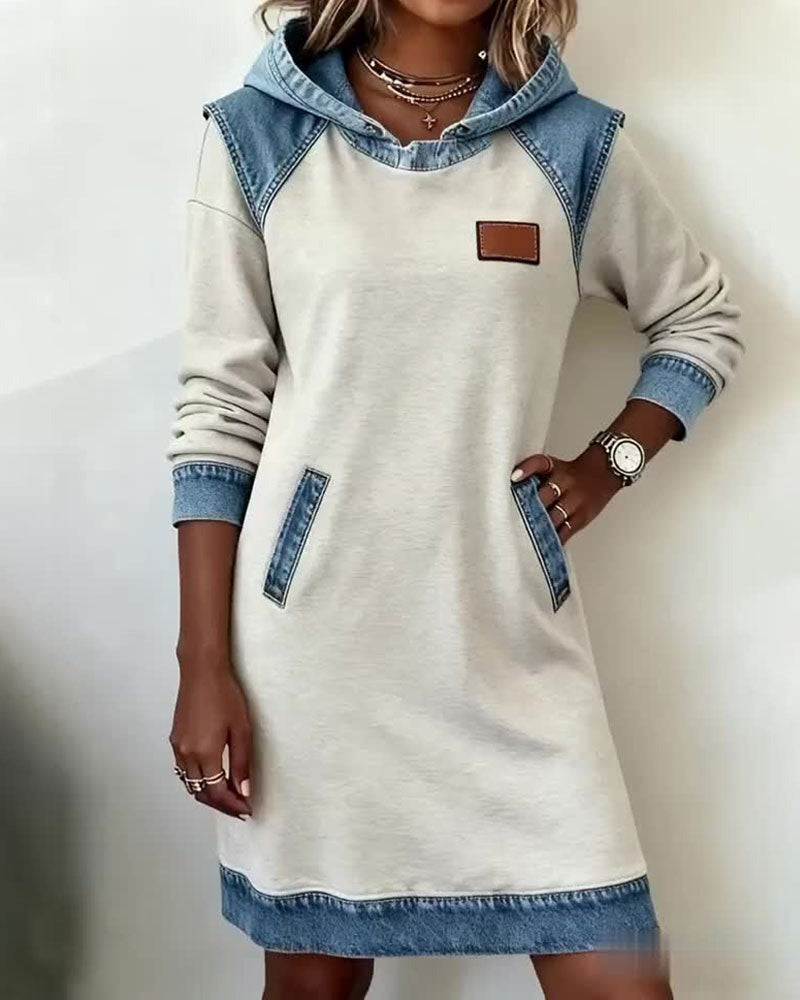 Urban chic women's hooded dress with relaxed fit and long sleeves, ideal for modern casual style. Easy wear comfort.