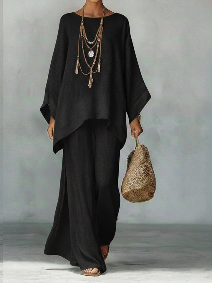 Women's comfortable linen two-piece set, with a relaxed poncho top & straight leg pants, perfect for summer.