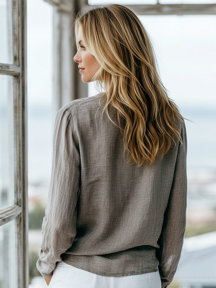Women's classic long sleeve Henley top with v-neck and button placket, relaxed fit, casual style.