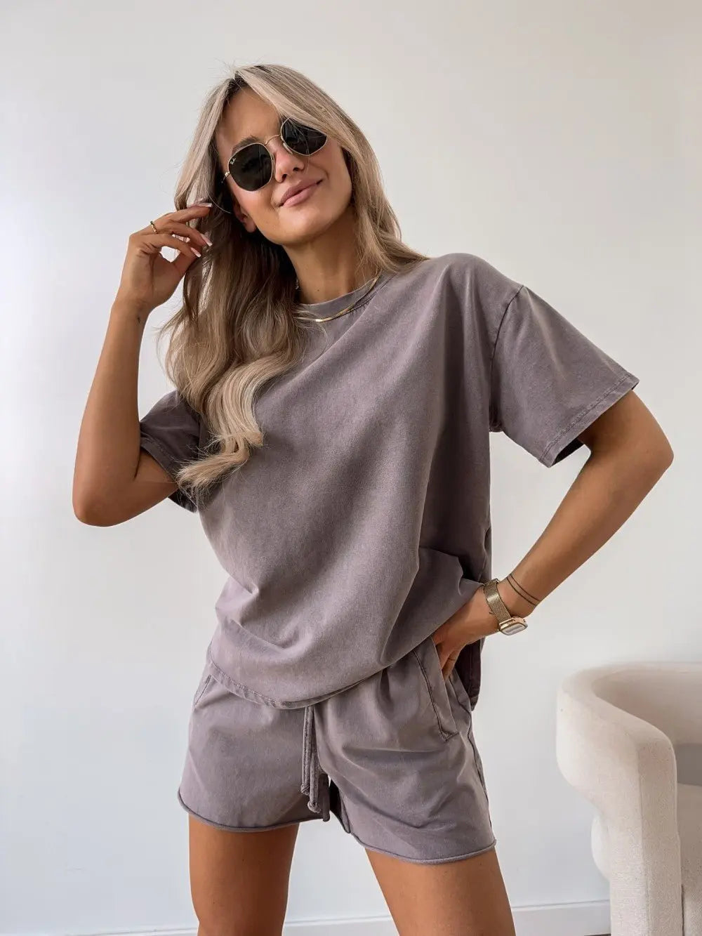Model wearing a women's relaxed fit two-piece loungewear set with matching shorts, great for summer comfort.