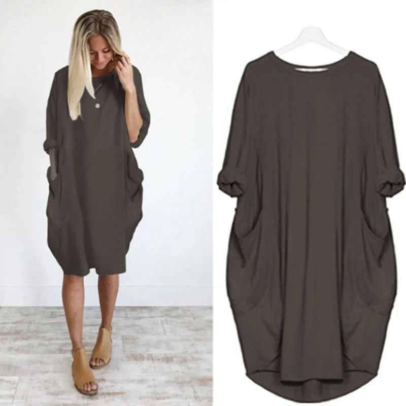 Midi length women's dress with relaxed fit, practical pockets, and stylish 3/4 sleeves for daily wear.