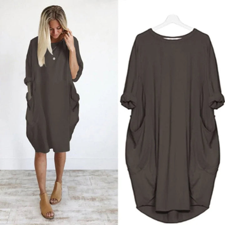 Midi length women's dress with relaxed fit, practical pockets, and stylish 3/4 sleeves for daily wear.