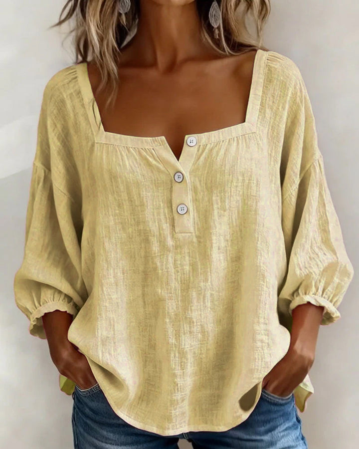 Women's spring blouse featuring puff sleeves, square neck, button front, and relaxed style.