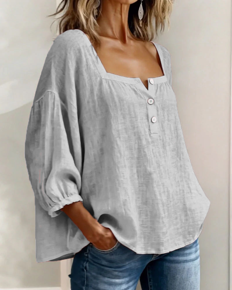 Elegant women's top with relaxed fit, puff sleeves, and a flattering square neck for chic looks.