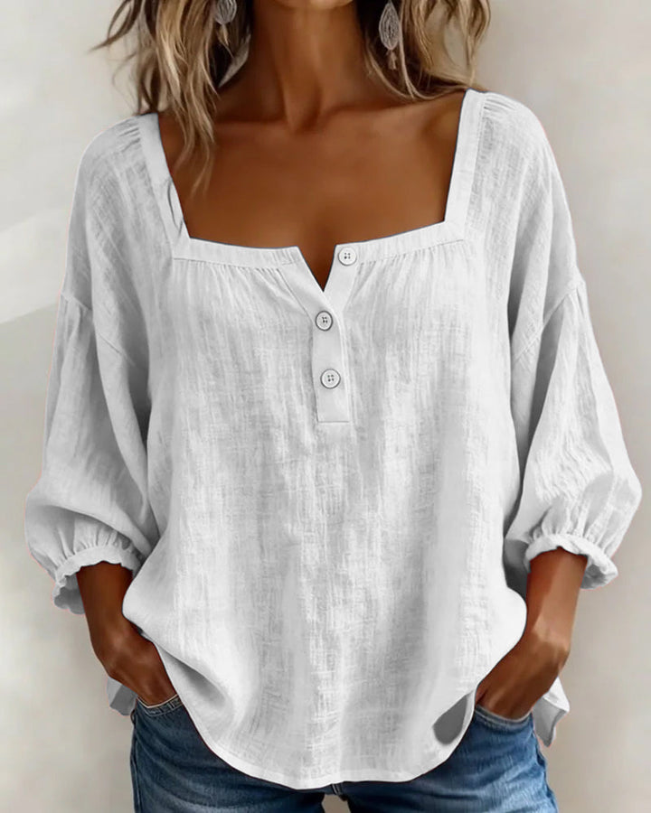 Chic women's top with relaxed fit, stylish puff sleeves, and a classic square neckline.