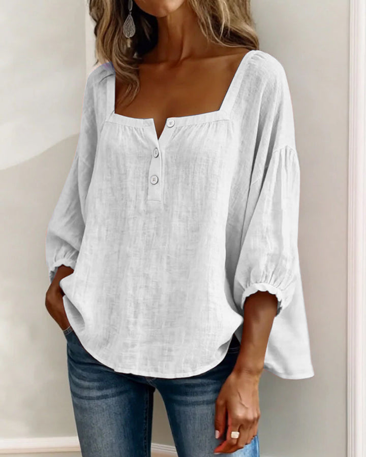 Casual yet elegant women's puff sleeve blouse with a square neck and relaxed silhouette.