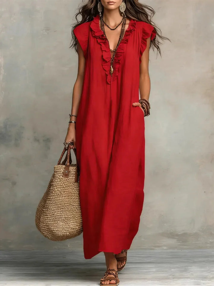 Stylish sleeveless maxi dress for women featuring a relaxed fit, ruffles, and practical pockets.