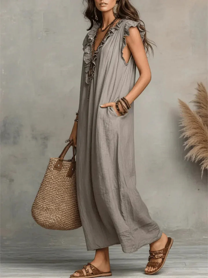 Fashionable women's sleeveless ruffle maxi dress with handy pockets, great for casual elegance.