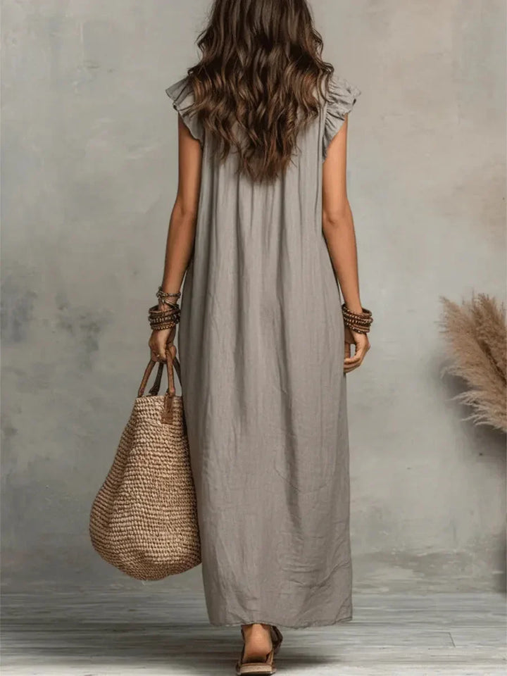 Relaxed fit women's v-neck maxi dress with ruffles & pockets, essential for summer fashion comfort.