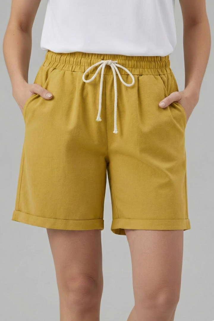 Practical women's relaxed fit shorts with adjustable drawstring and deep pockets, ideal for warm weather.