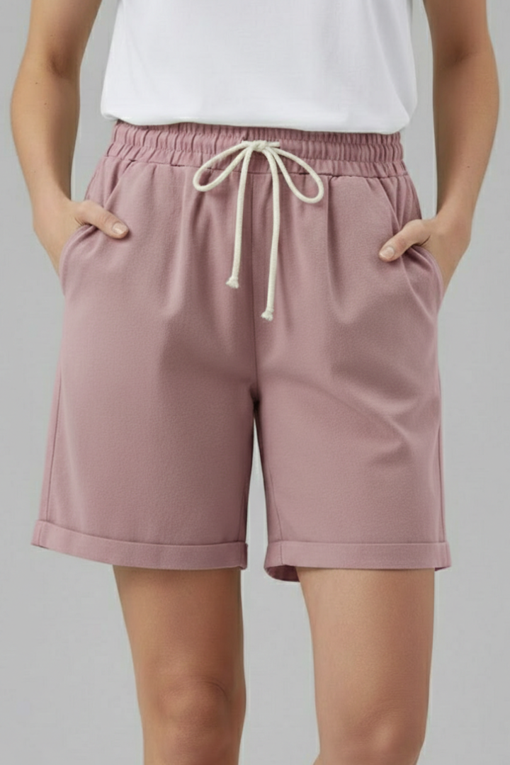 Chic women's relaxed fit shorts featuring a drawstring waist & practical pockets, an essential for summer.