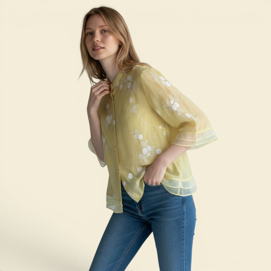 Women's relaxed fit summer blouse with delicate floral embroidery and button front.