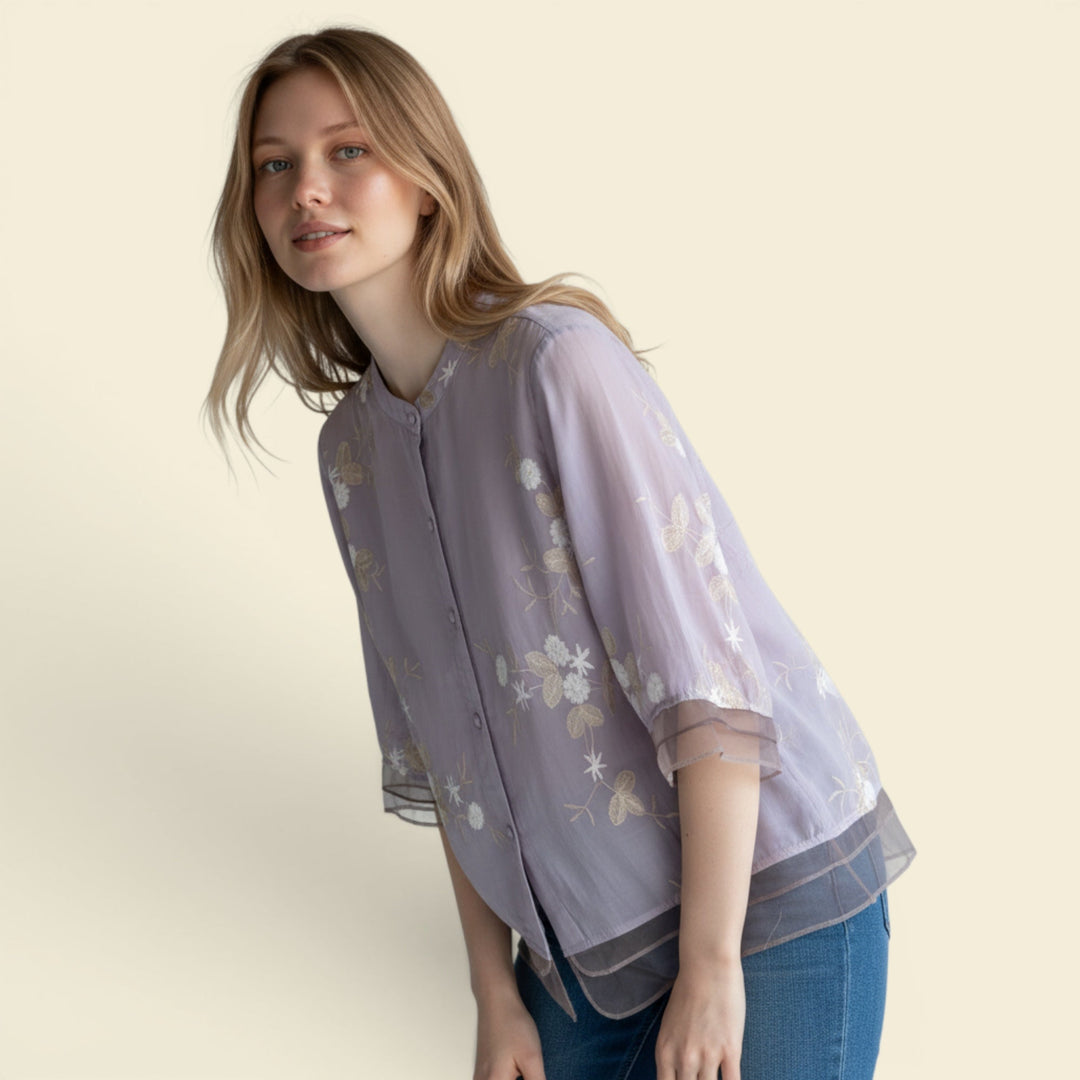 Button-front women's blouse, loose fit, with intricate floral embroidery. Perfect for summer fashion.