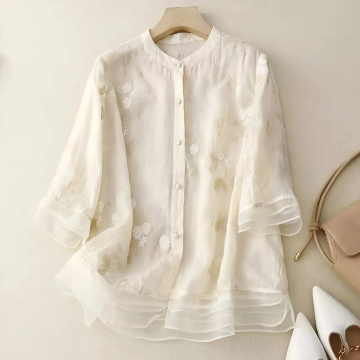 Women's casual summer blouse, relaxed fit, with beautiful floral embroidery. Button-down style.