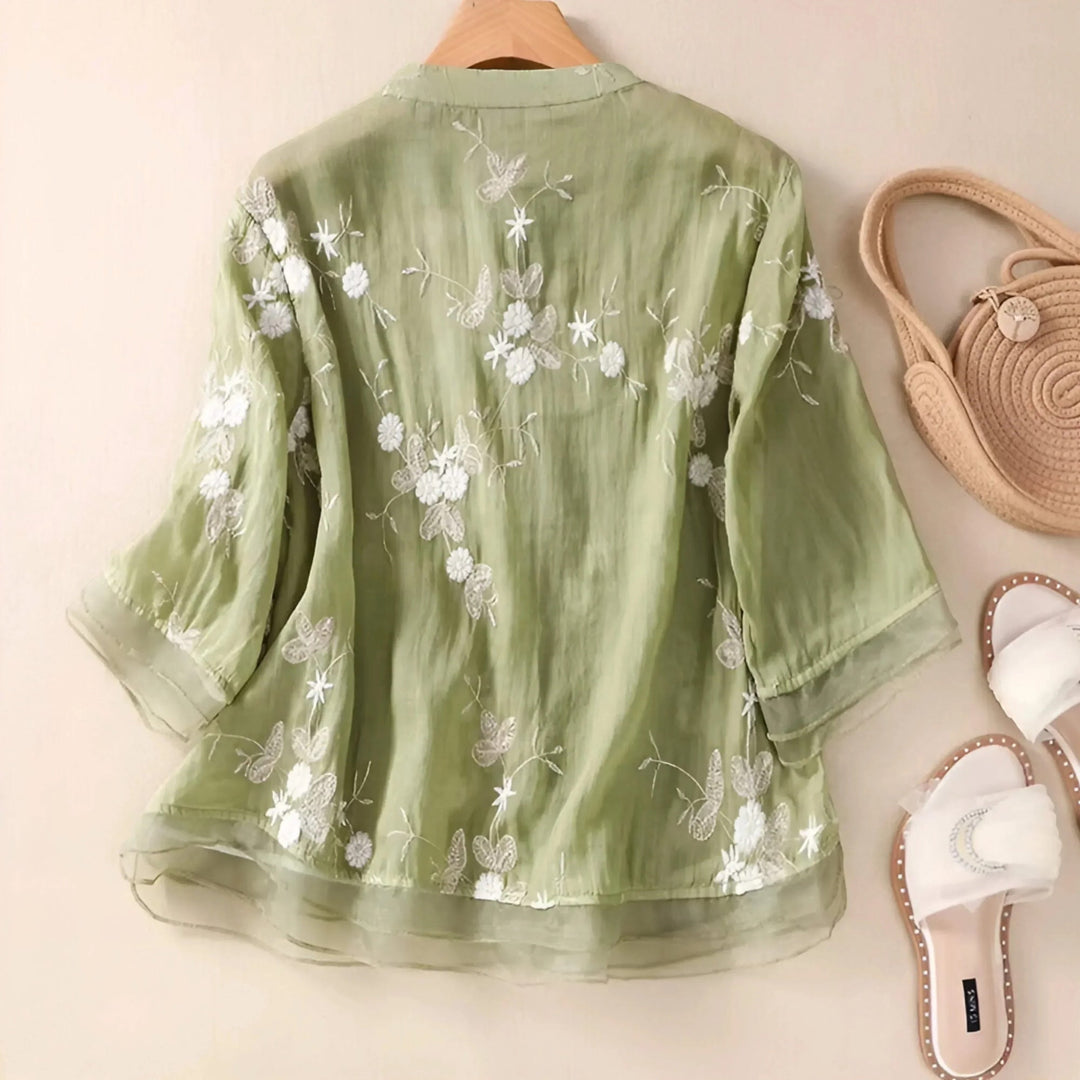 Comfortable women's relaxed fit blouse, summer style, with intricate floral embroidery and button front.