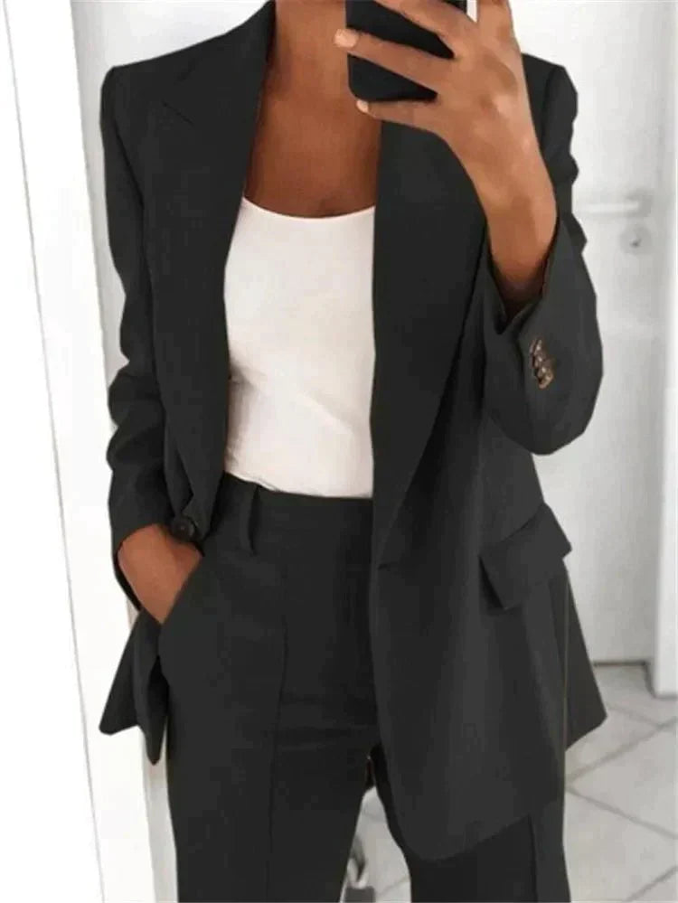 Comfortable women's relaxed fit suit with a tailored blazer & straight-leg trousers, ideal for professional wear.