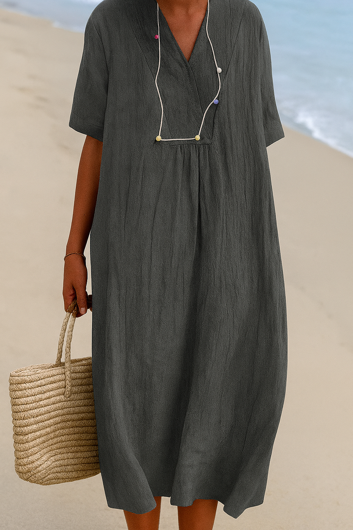 Women's relaxed fit V-neck beach dress with short sleeves, perfect for summer vacation wear.