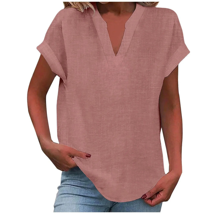 Close-up of cuffed short sleeves on a women's relaxed V-neck blouse, ideal for summer style.