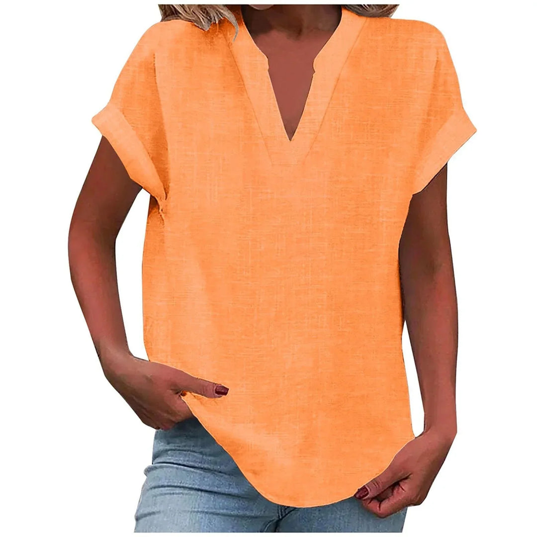 Woman wearing a relaxed V-neck blouse with cuffed short sleeves, showcasing versatile everyday wear.