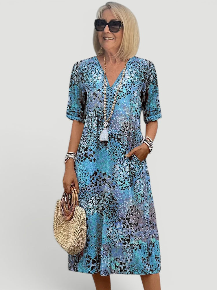 Casual women's summer midi dress, V-neck, relaxed fit. Lightweight, possibly printed, perfect for easy everyday wear.