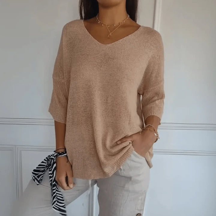 Elegant women's 3/4-sleeve V-neck top in a relaxed fit, ideal for versatile spring and fall fashion.