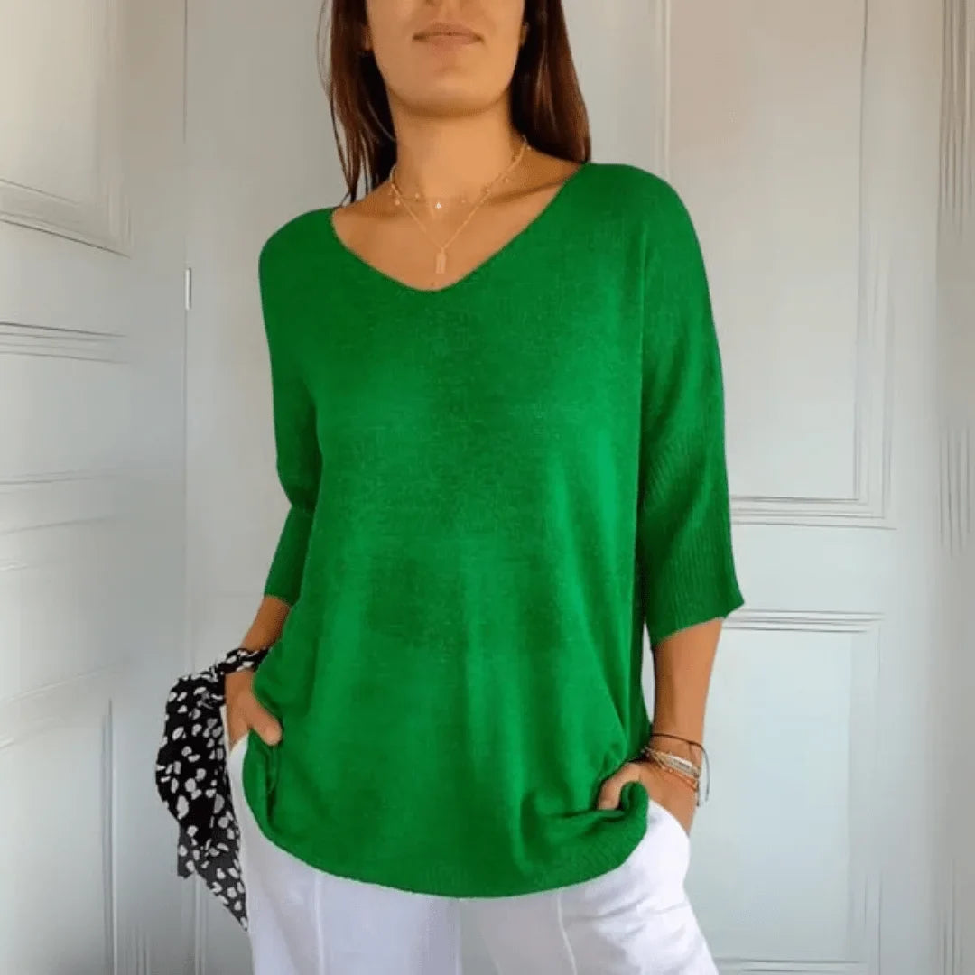 Front view of a women's relaxed fit V-neck 3/4-sleeve top, showcasing its soft drape and elegant cut.