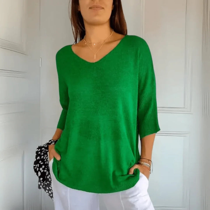 Front view of a women's relaxed fit V-neck 3/4-sleeve top, showcasing its soft drape and elegant cut.